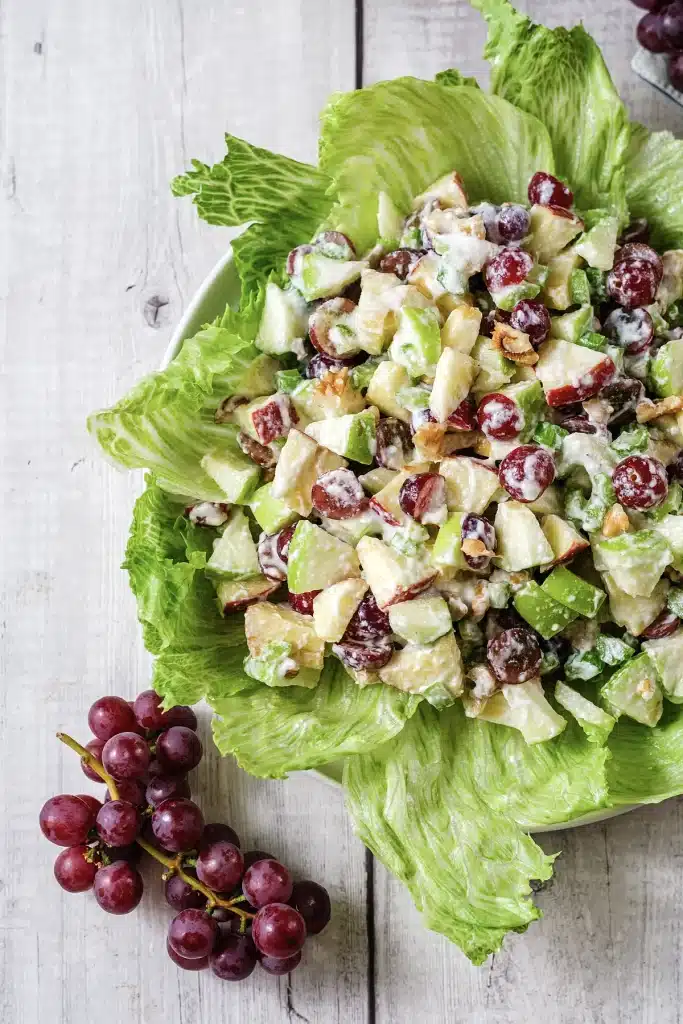 Classic Waldorf salad seen from directly above, filling a white bowl on lettuce