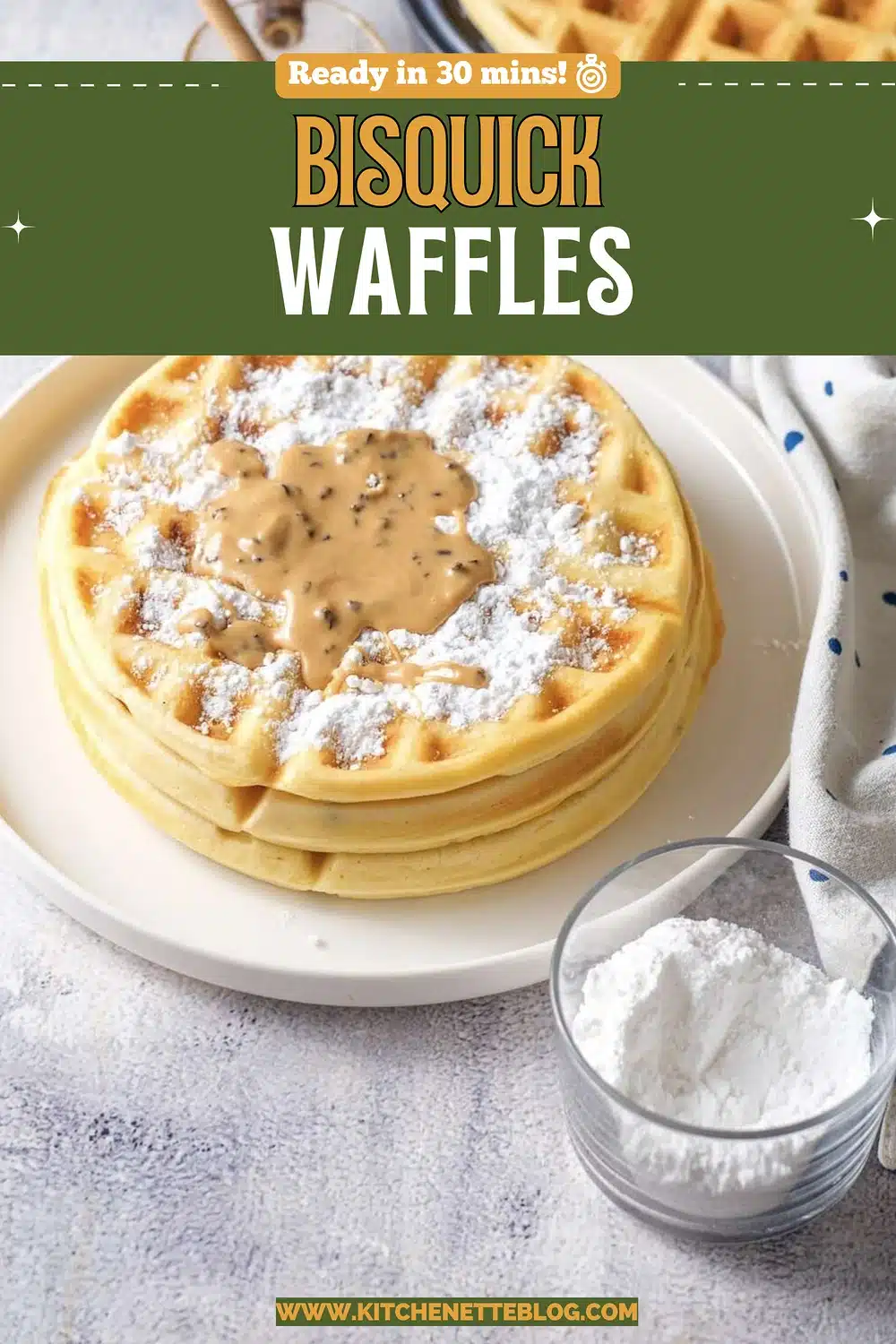 A stack of golden grid-patterned rounds dusted with powdered sugar on a white plate beside a honey dipper