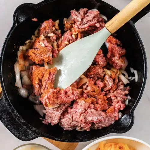The seasoning stirred through the beef with a spatula
