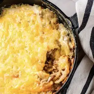 A spoonful of taco hashbrown casserole lifted from the skillet